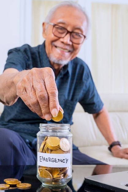 Man Putting Money in Emergency Fund